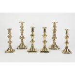 THREE PAIRS OF ANTIQUE BRASS CANDLESTICKS WITH OBLONG BASES, one pair still with ejectors, 11" (