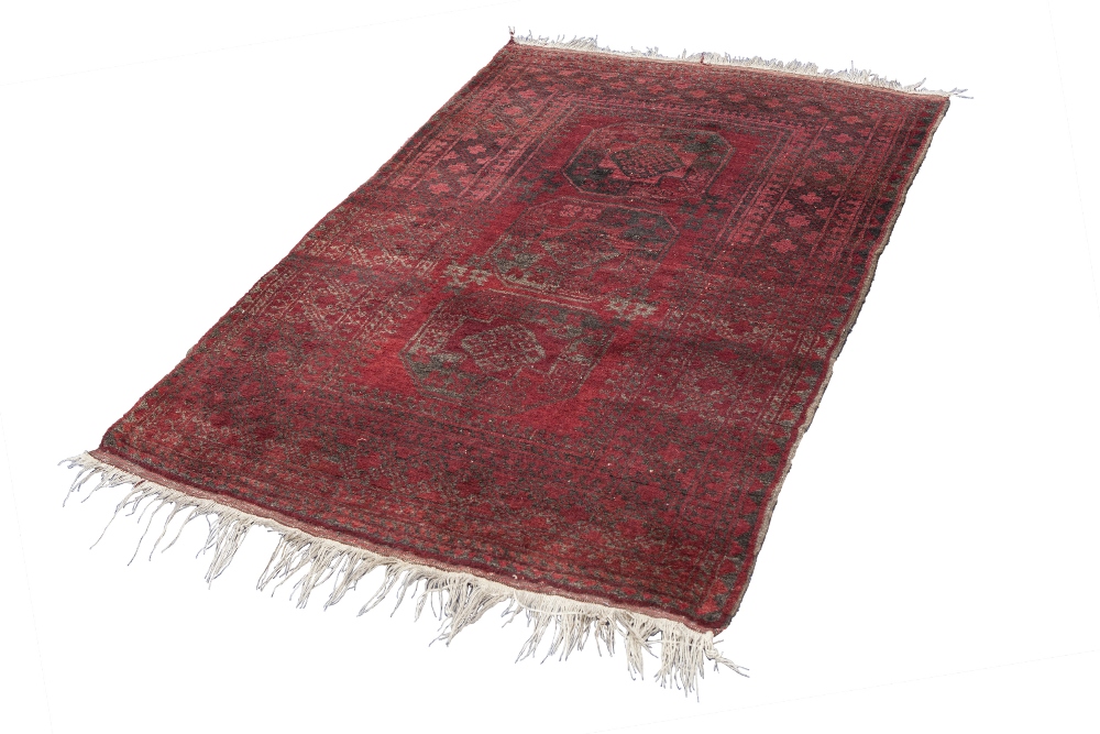 TURKOMAN HEAVY QUALITY TRIBAL RUG, with three large octagonal guls on a crimson field, the principal