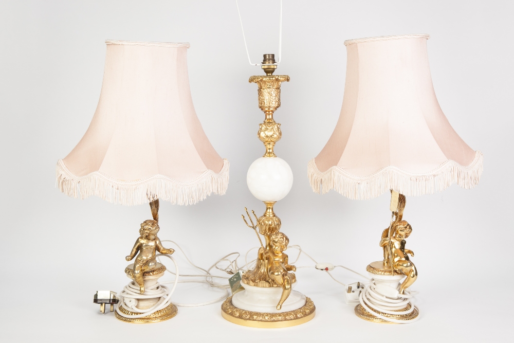 PAIR OF MODERN GILT METAL TABLE LAMPS SURMOUNTED BY CHERUBS, AND ANOTHER, SIMILAR, LARGER EXAMPLE,