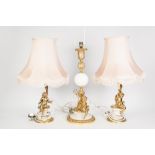 PAIR OF MODERN GILT METAL TABLE LAMPS SURMOUNTED BY CHERUBS, AND ANOTHER, SIMILAR, LARGER EXAMPLE,