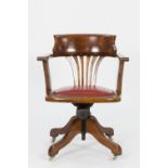 EARLY TWENTIETH CENTURY STAINED BEECH RECLINING OPEN ARM DESK CHAIR, of tub form with pierced splat,