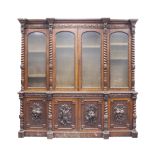 IMPRESSIVE NINETEENTH CENTURY CARVED OAK BREAKFRONT BOOKCASE, the cornice carved with acanthus