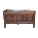 EIGHTEENTH CENTURY CARVED OAK COFFER, of typical form with candle box to the interior, and three