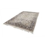 EASTERN CARPET, finely knotted, with pale gold and floral centre medallion with pendants on an off