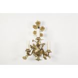 SET OF FOUR FLORAL CAST ORMOLU THREE BRANCH WALL LIGHTS, each modelled with foliate scroll arms