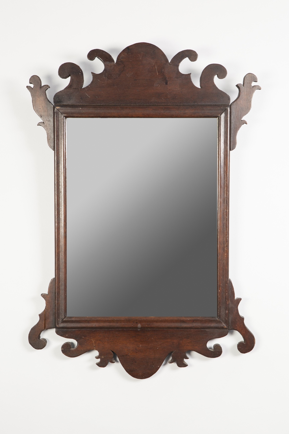 NINETEENTH CENTURY MAHOGANY WALL MIRROR IN THE GEORGE II STYLE, the oblong plate in a moulded