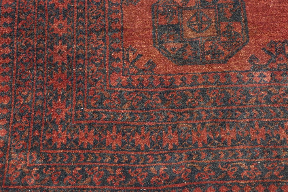 TURKOMAN BOKHARA RUG, with two rows of large stencilled black guls on a crimson field, multiple - Image 2 of 2