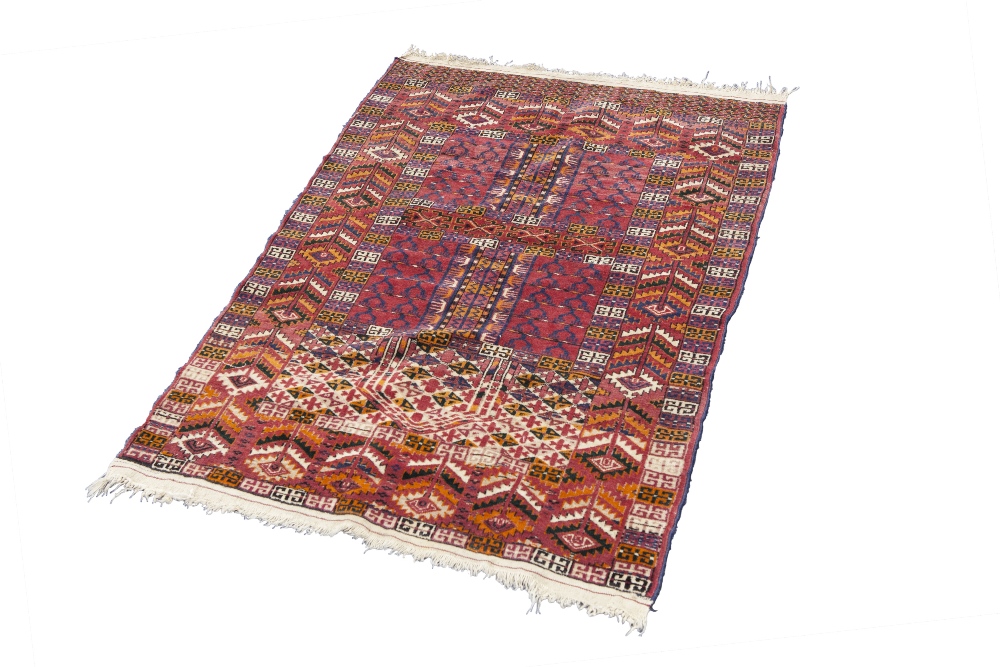 A FINELY KNOTTED AND INTRICATELY PATTERNED TURKOMAN PRAYER RUG, the central field divided into