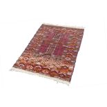 A FINELY KNOTTED AND INTRICATELY PATTERNED TURKOMAN PRAYER RUG, the central field divided into