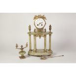 EARLY TWENTIETH CENTURY FRENCH GILT METAL AND GREEN ONYX PORTICO MANTEL CLOCK, the 4" enamelled