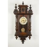 EARLY TWENTIETH CENTURY VIENNA STYLE CARVED WALNUTWOOD AND FRUITWOOD WALL CLOCK, the 6" Roman dial