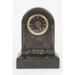 LATE VICTORIAN BLACK SLATE MANTEL CLOCK WITH VEINED MARBLE TRIM, the 6" Roman dial powered by a drum