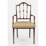 EDWARDIAN CARVED MAHOGANY CARVER ARMCHAIR, in the Sheraton style, the moulded back with arched top
