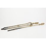 PAIR OF BRASS FIRE TONGS, with wrythen fluted top, TOGETHER WITH THE MATCHING POKER, (2)