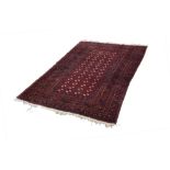 TURKOMAN BOKHARA RUG, with four tows of small black and white stencilled guls on a wine red field,