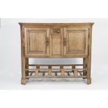 NINETEENTH CENTURY CONTINENTAL OAK SIDE CABINET, the canted oblong top above a pair of moulded
