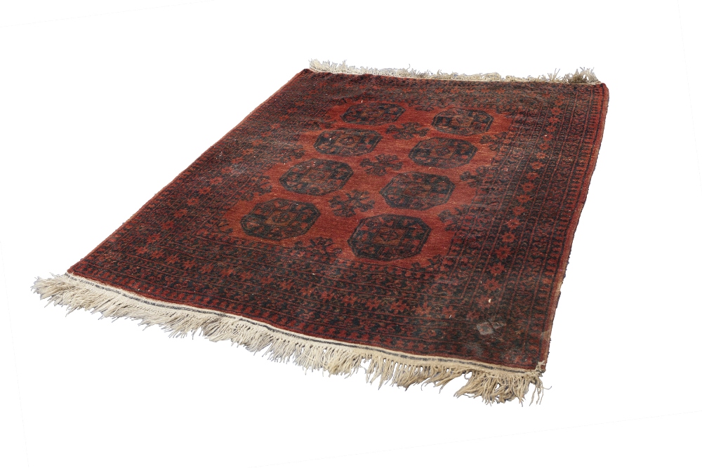 TURKOMAN BOKHARA RUG, with two rows of large stencilled black guls on a crimson field, multiple