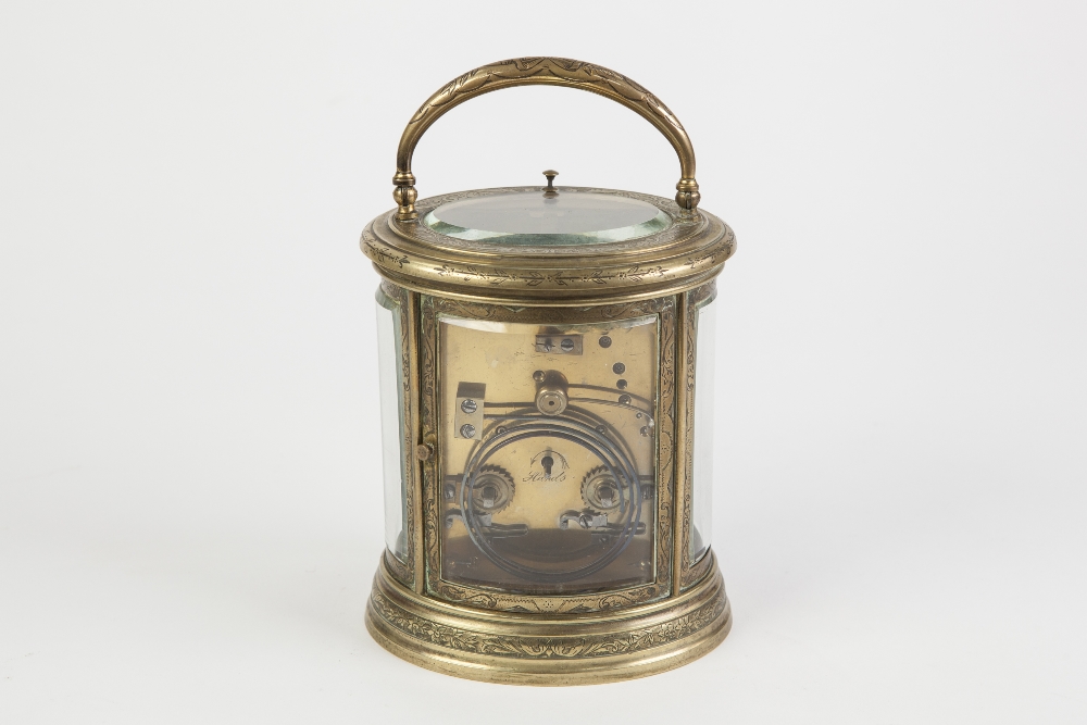 A LATE 19TH CENTURY REPEAT CARRIAGE CLOCK in scroll engraved brass oval case with four curved - Image 2 of 2