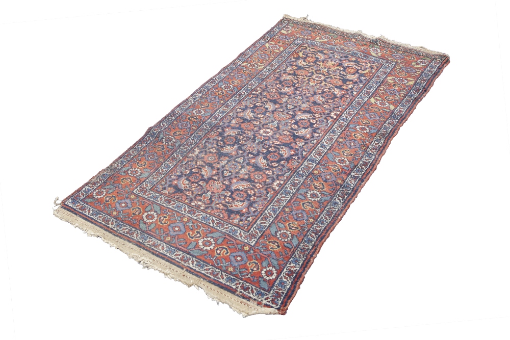 SHIRAZ PERSIAN RUG, with all over formal floral pattern on a midnight blue field, broad red and