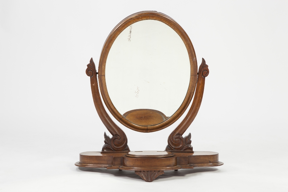 VICTORIAN CARVED MAHOGANY TOILET MIRROR, the oval plate in a moulded frame, flanked by scroll
