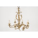 EIGHT LIGHT ORMOLU ELECTROLIER IN THE ROCOCO STYLE, with leaf cast scroll arms and candle pattern