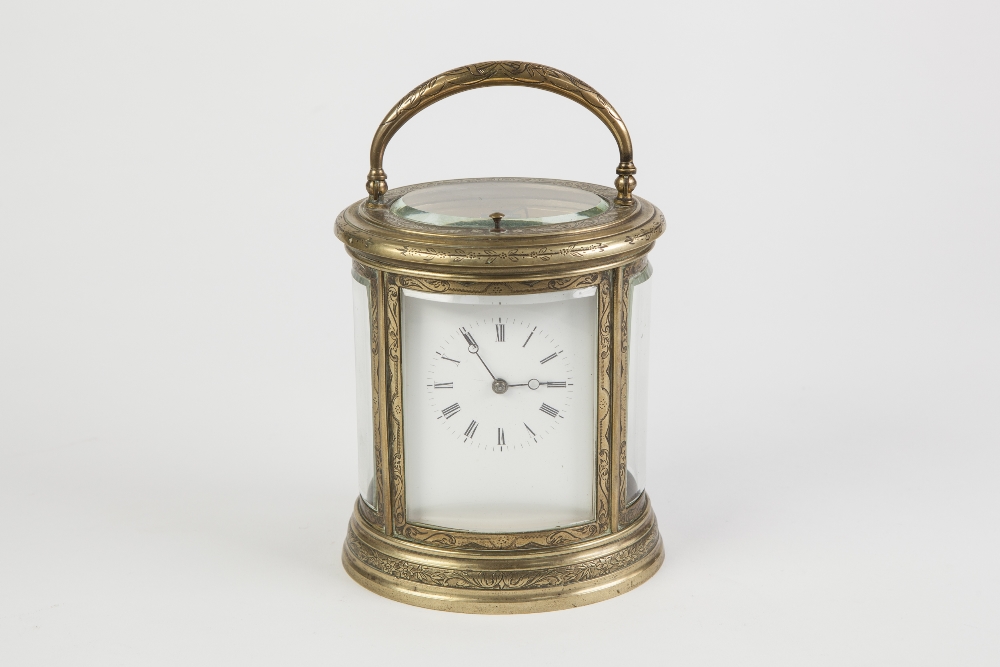 A LATE 19TH CENTURY REPEAT CARRIAGE CLOCK in scroll engraved brass oval case with four curved