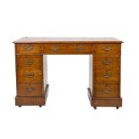 LATE VICTORIAN OAK TWIN PEDESTAL DESK, of typical form with gilt tooled 'antique' red leather