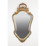 MODERN GILT AND GREEN PAINTED COMPOSITION WALL MIRROR IN THE ROCOCO STYLE, the shield shaped bevel