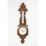 W. ARONSBERG, MANCHESTER, CARVED OAK ANERIOD BAROMETER, the 6" dial in a scroll carved banjo