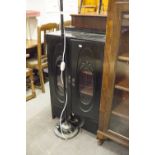 EBONISED MUSIC CABINET WITH TWO GLAZED DOORS ENCLOSING SHELVES AND HAVING A DRAWERS BELOW (2'1"