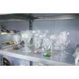 A COLLECTION OF ETCHED DRINKING GLASSES AND CUT GLASSES AND A CANDLESTICK STAND SUITE