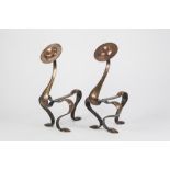 PAIR OF ARTS AND CRAFTS PLANISHED COPPER ANDIRONS, each of curved strap work form with disc shaped