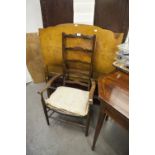 A WALNUTWOOD PANEL SINGLE BEDSTEAD AND A LADDER BACK NURSING CHAIR
