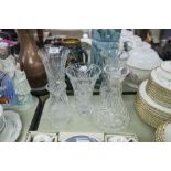 A COLLECTION OF CUT GLASS WARES, TO INCLUDE; FOUR VASES AND A DECANTER WITH A STOPPER (5)