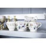 SIX EARLY VICTORIAN CHINA TEA CUPS AND SAUCER AND A MILK JUG WITH PRINTED AND COLOURED FLORAL