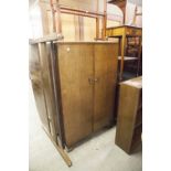 AN OAK DOUBLE CUPBOARD, THE DOORS ENCLOSING FOUR SHELVES