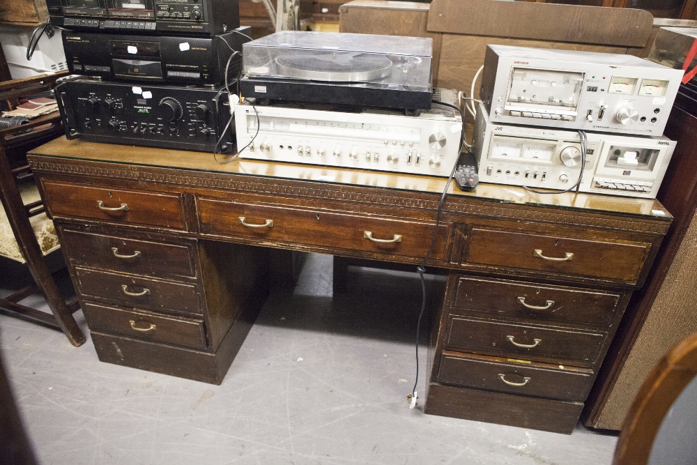 A TWENTIETH CENTURY MAHOGANY DOUBLE PEDESTAL DESK WITH NINE DRAWERS, ON PLINTH BASES, 5;6" X 1'8"