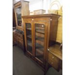 MAHOGANY BOOKCASE, HAVING TWO GLAZED DOORS AND THREE DRAWERS BELOW ON BRACKET FEET