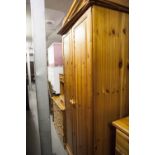 A FOUR PIECE PINE MODERN BEDROOM SUITE TO INCLUDE; TWO DOUBLE WARDROBES, ONE OVER DRAWER, BEDSIDE