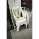 A SET OF FOUR WHITE PLASTIC STACKING GARDEN CHAIRS AND CIRCULAR TABLE