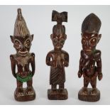 TWO YORUBA CARVED WOOD IBEJI FIGURES, with beadwork necklaces, and another, similar maternity