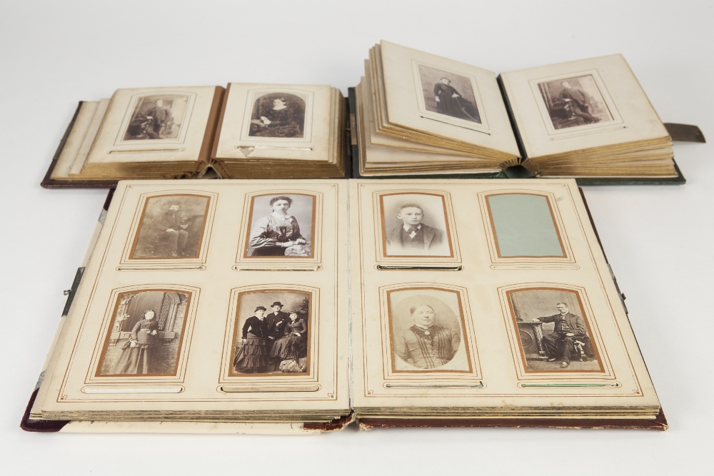 TWO VICTORIAN SMALL PHOTOGRAPH ALBUMS with embossed leather bindings and metal hasps, approx 6" x 5"