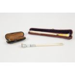 TWO IVORY AND GUILLOCHE ENAMELLED CIGARETTE HOLDERS, one cased and with gilt metal mount and