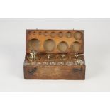 COMPLETE SET OF TWELVE BRASS JEWELLERS GOLD WEIGHTS, 1-500gram, in fitted beechwood box