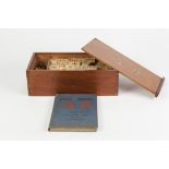 AN INTER-WAR YEARS CHINESE MAH JONG SET with bamboo pieces, contained in original wooden box with