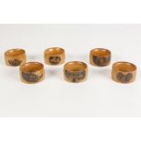 SIX MAUCHLINE WARE NAPKIN RINGS OF VERY SIMILAR COLOUR AND SIZE, varying views of Dunkeld House, the