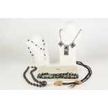 SINGLE STRAND NECKLACE OF BLACK AND FLORAL MILLEFIORI GLASS UNIFORM ROUND BEADS and the pair of