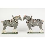 PAIR OF FRETWORKED AND PAINTED WOOD SILHOUETTE ORNAMENTS in the form of Shire horses wearing collars