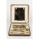 CIRCA 1920's BOXED MANICURE AND DRESSING TABLE SET of ten pieces, gilt metal an steel four pieces