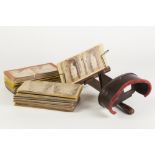 EARLY 20th CENTURY STAINED WOOD HAND-HELD STEREOSCOPIC VIEWER of typical form with folding handle